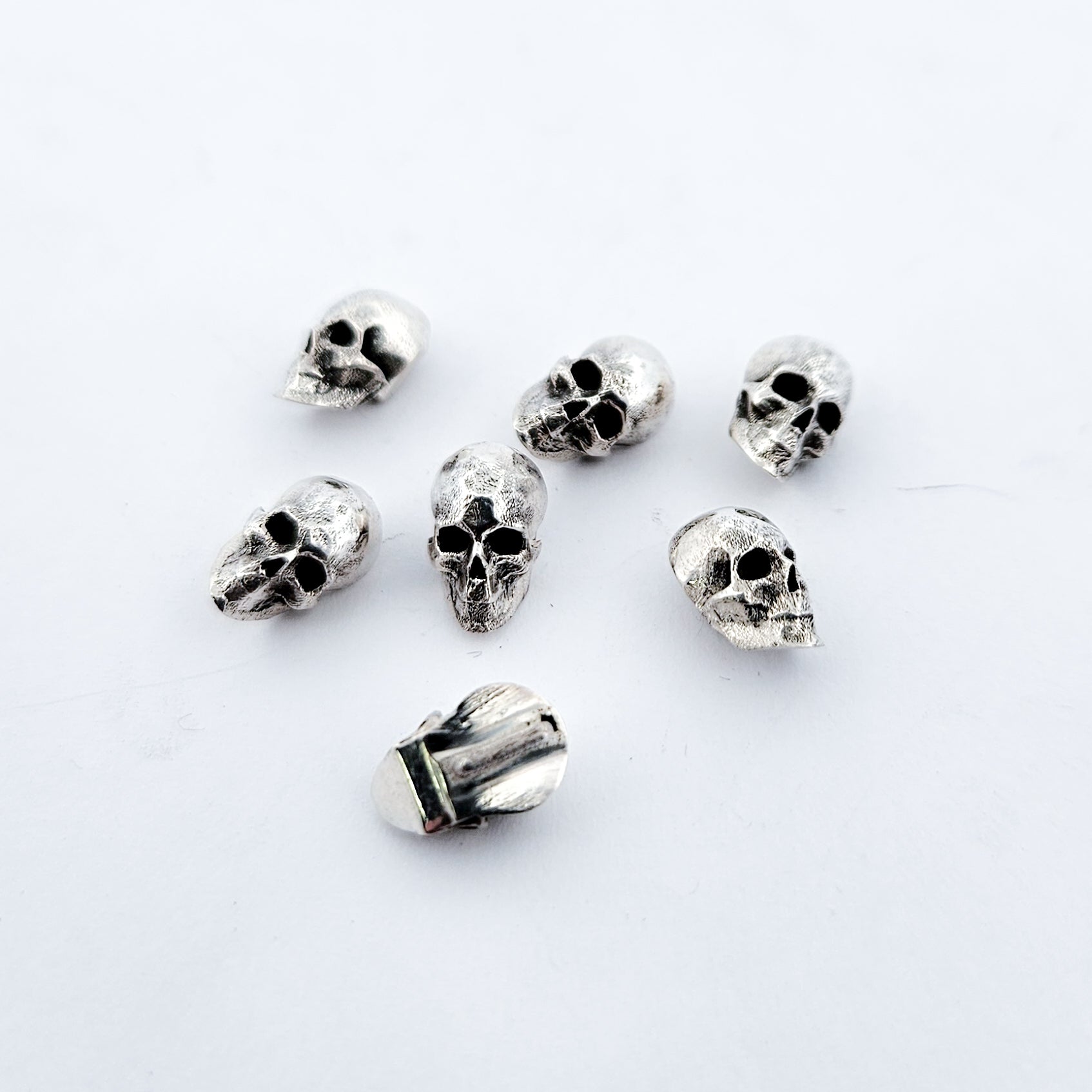 Collection of Sterling Silver Skull Buttons in a gallery layout