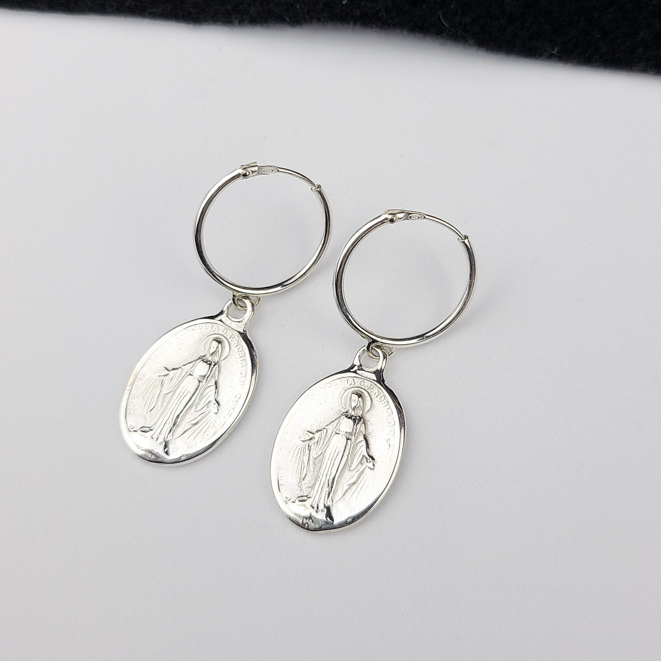 Collection of Oval Virgin Mary Medallion Hoop Earrings in a gallery layout