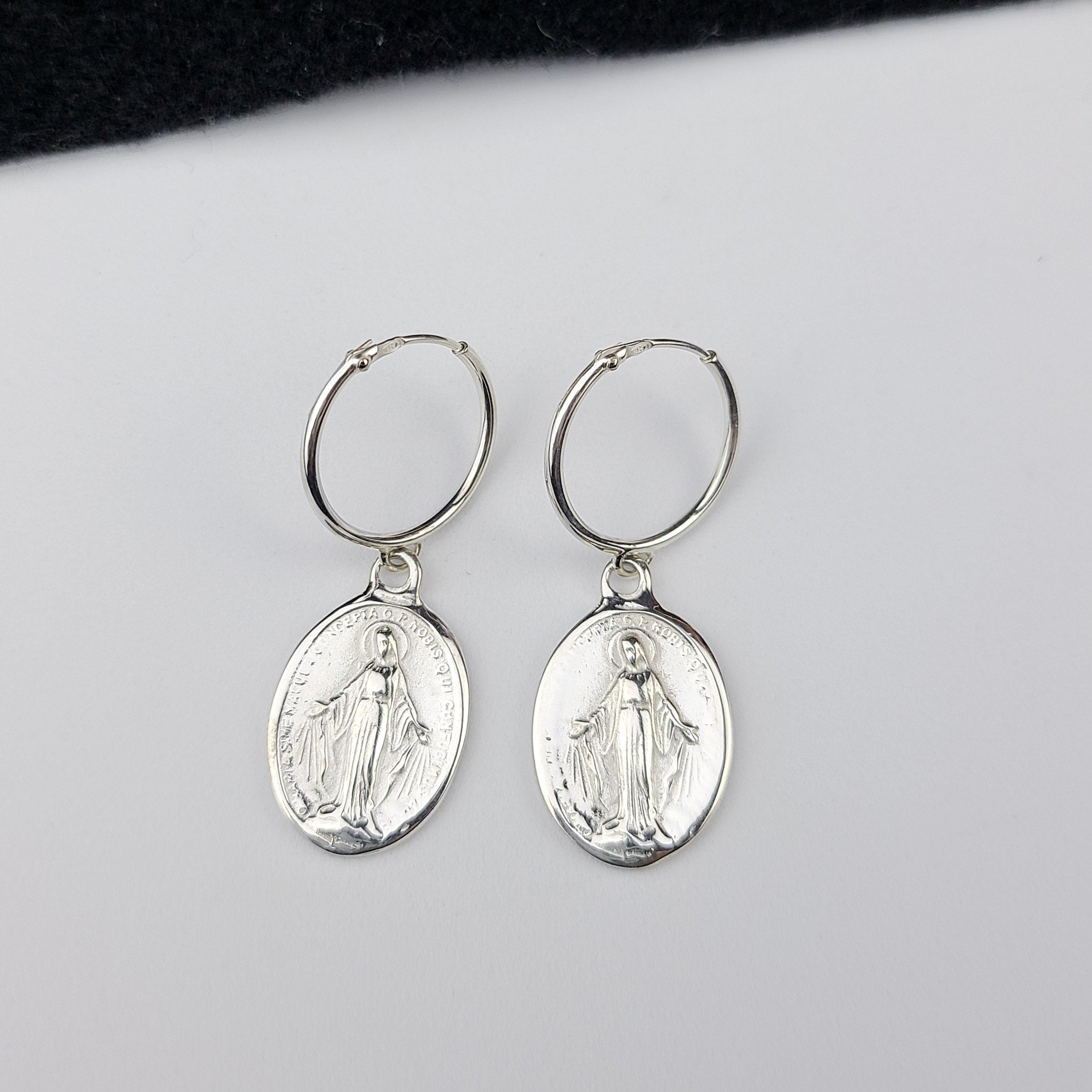 Collection of Oval Virgin Mary Medallion Hoop Earrings in a gallery layout