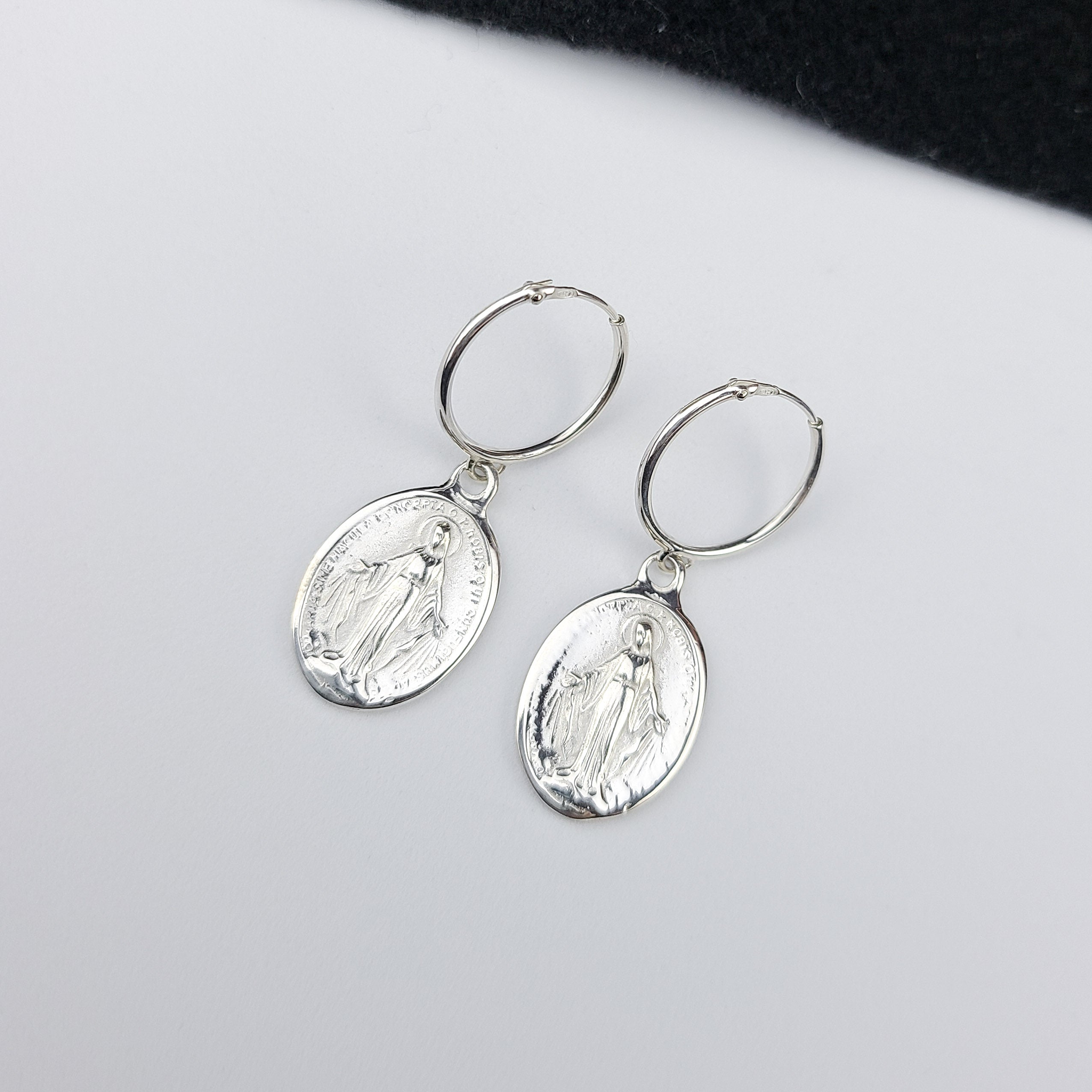 Collection of Oval Virgin Mary Medallion Hoop Earrings in a gallery layout