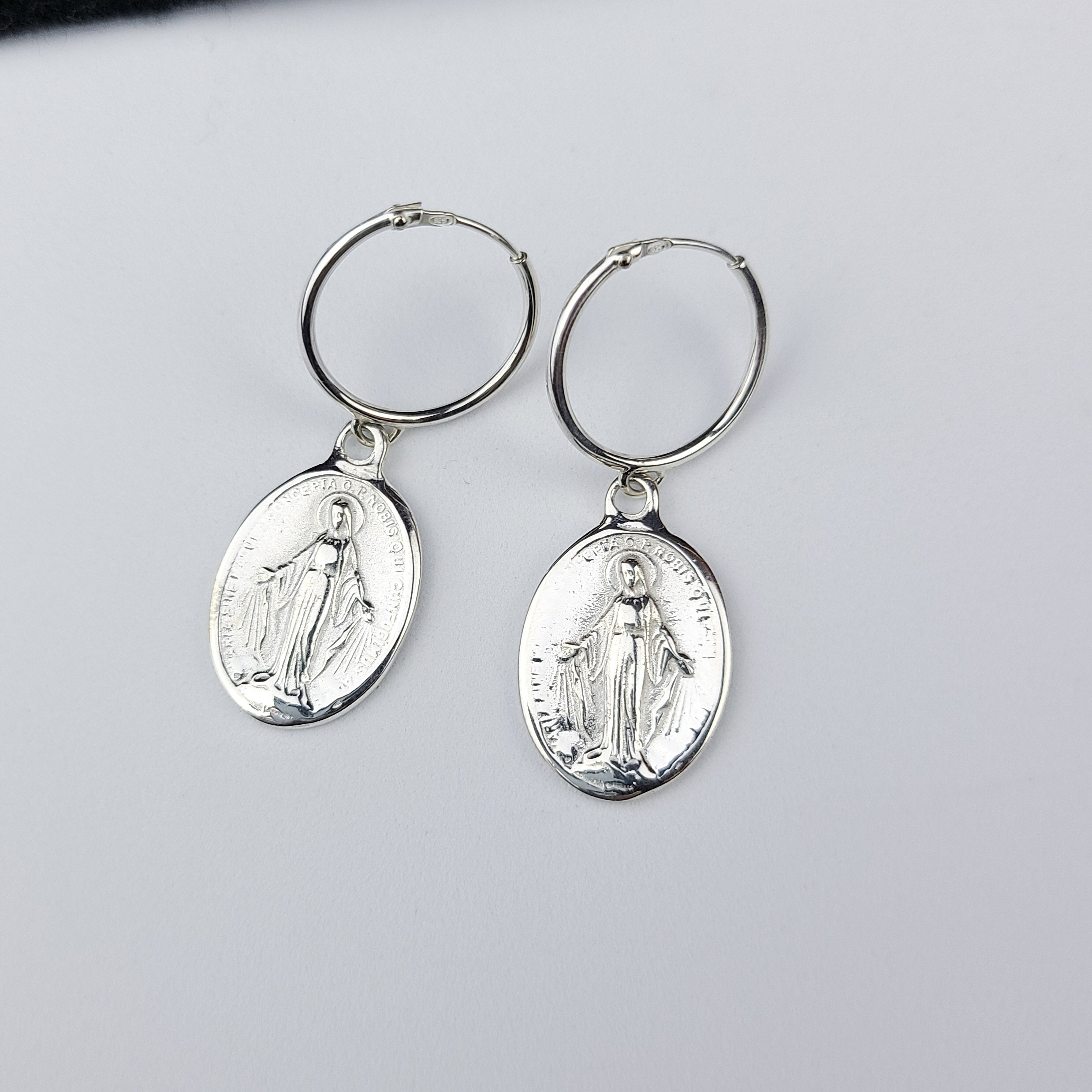 Collection of Oval Virgin Mary Medallion Hoop Earrings in a gallery layout