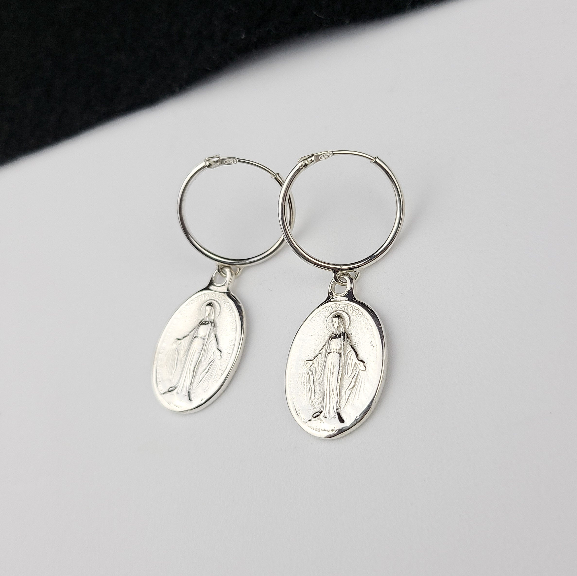 Collection of Oval Virgin Mary Medallion Hoop Earrings in a gallery layout