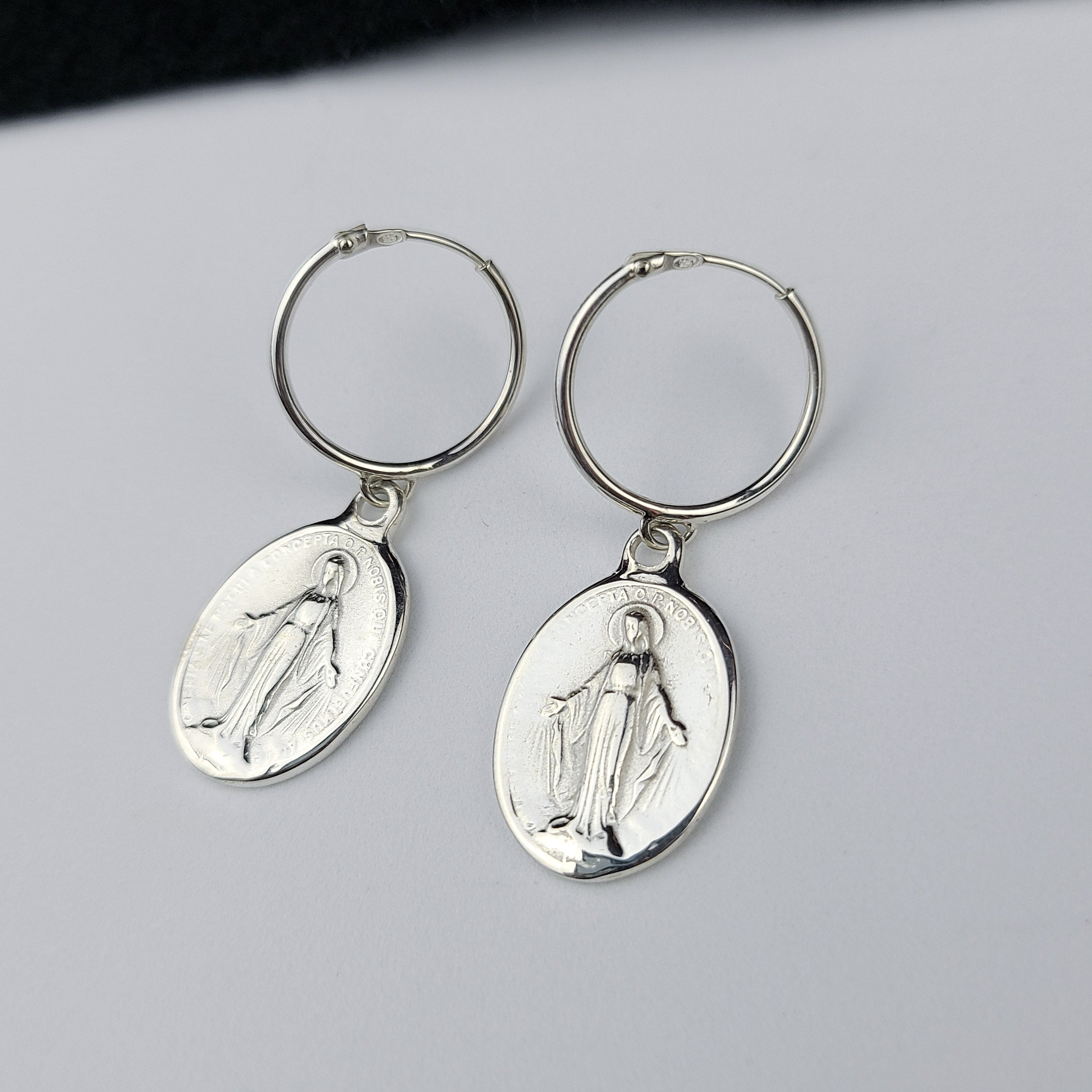 Collection of Oval Virgin Mary Medallion Hoop Earrings in a gallery layout