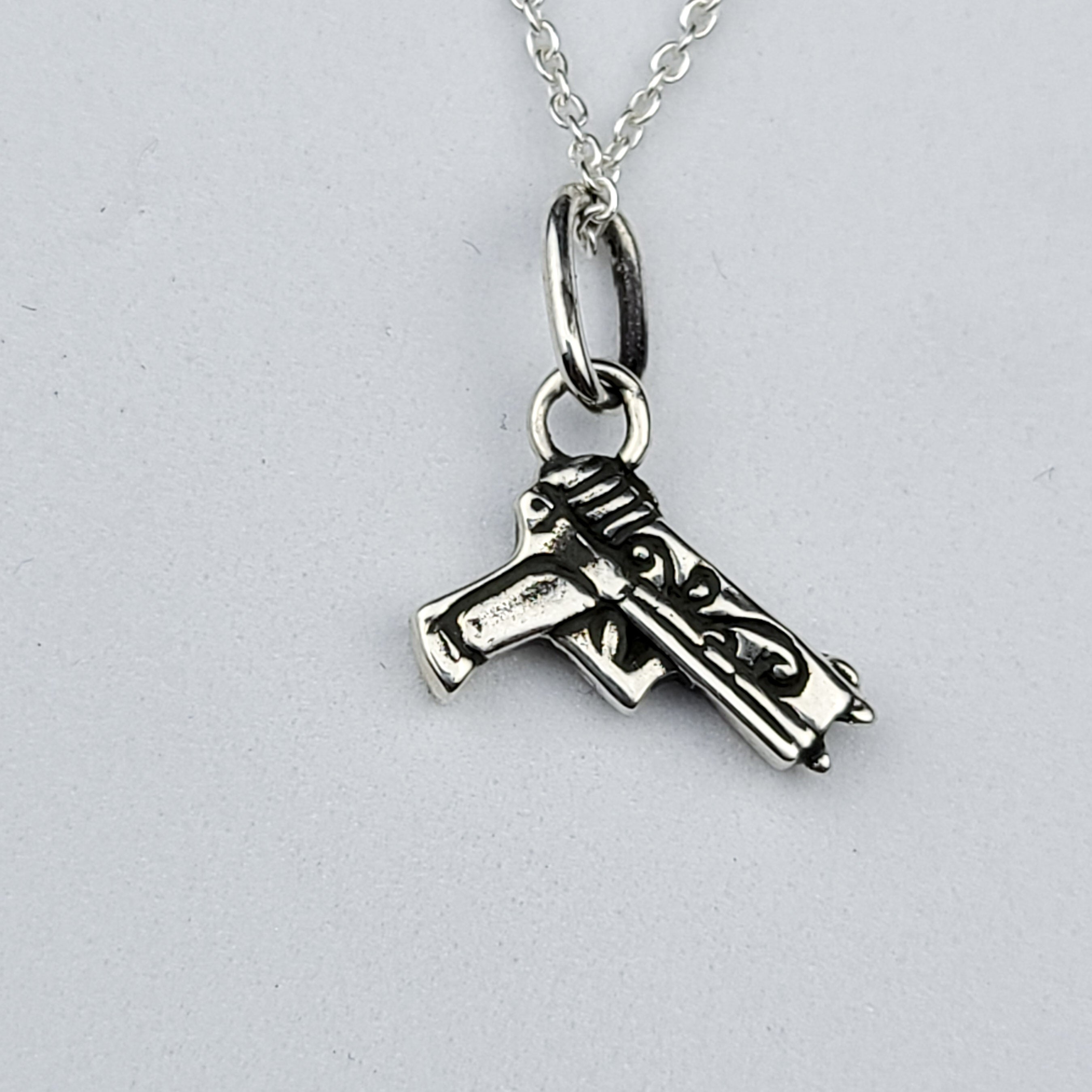 Tiny Silver Gun with Roses Pendant