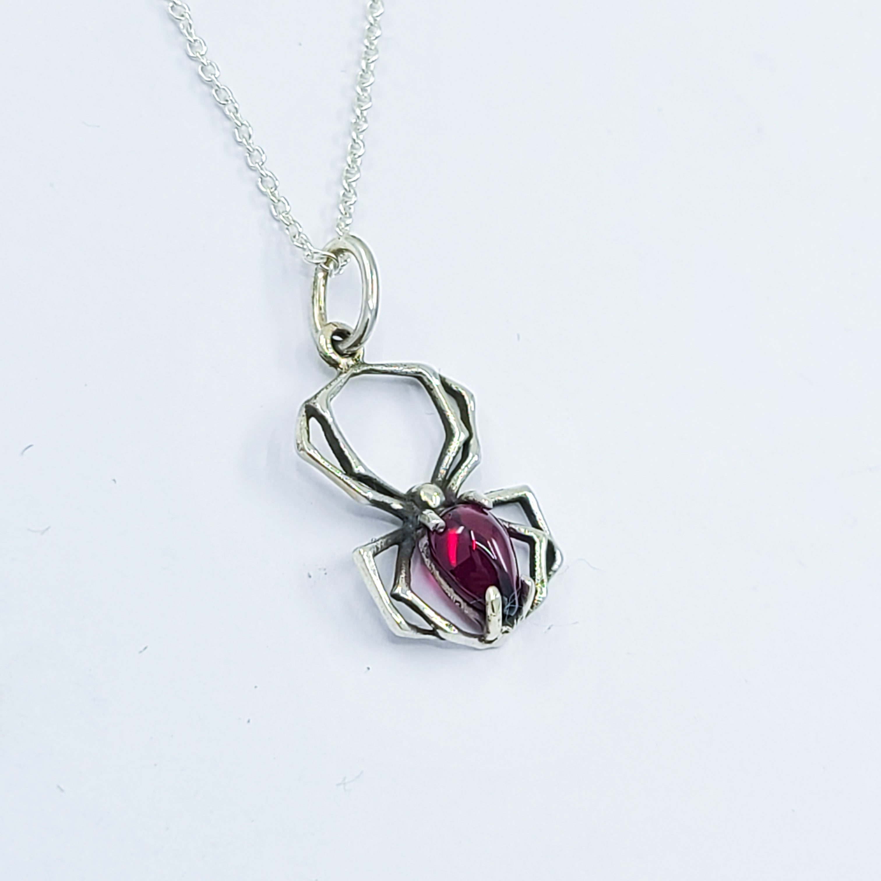 Collection of Radiant Red Garnet Cab Spider Pendant in a gallery layout